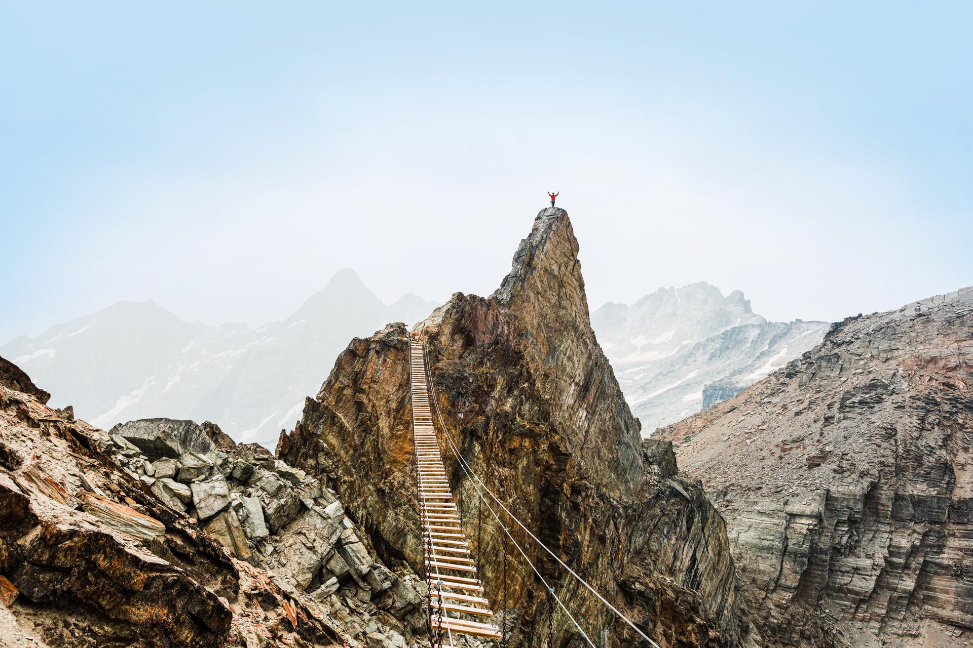 A person hiking in Alberta at the top of a summit