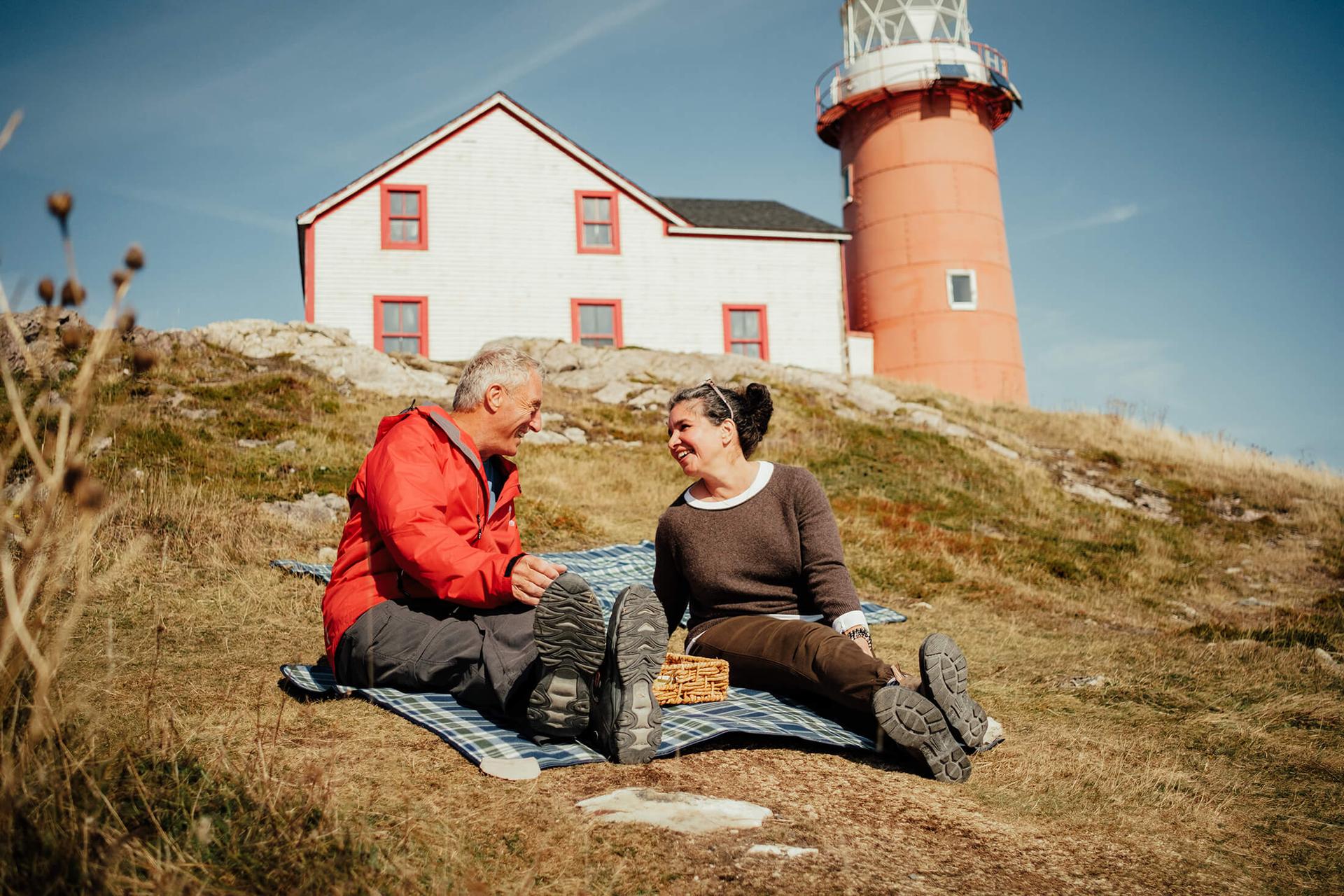 A couple have a picnic on the rocks