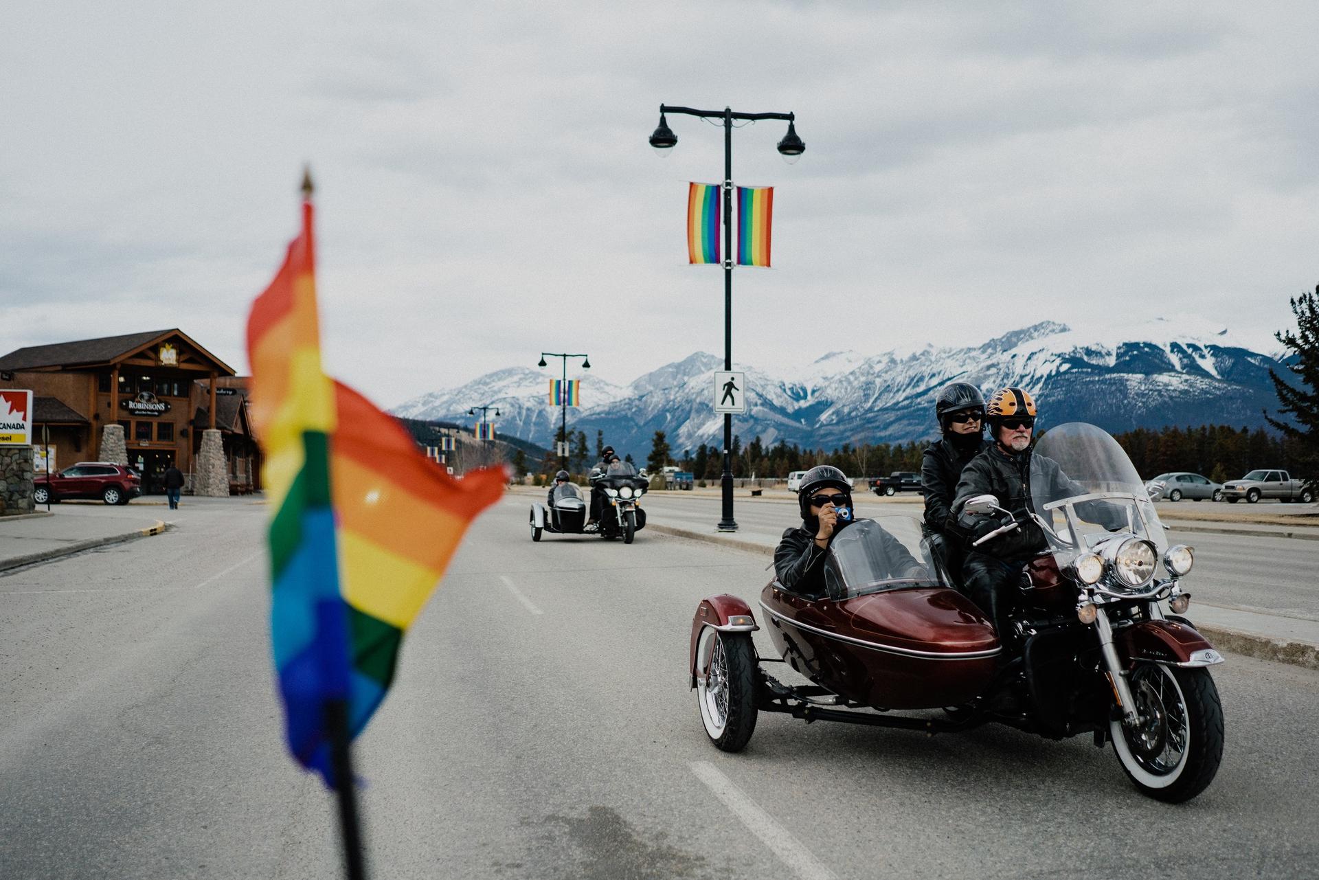 Motorcyclists celebrate pride with flags in Jasper