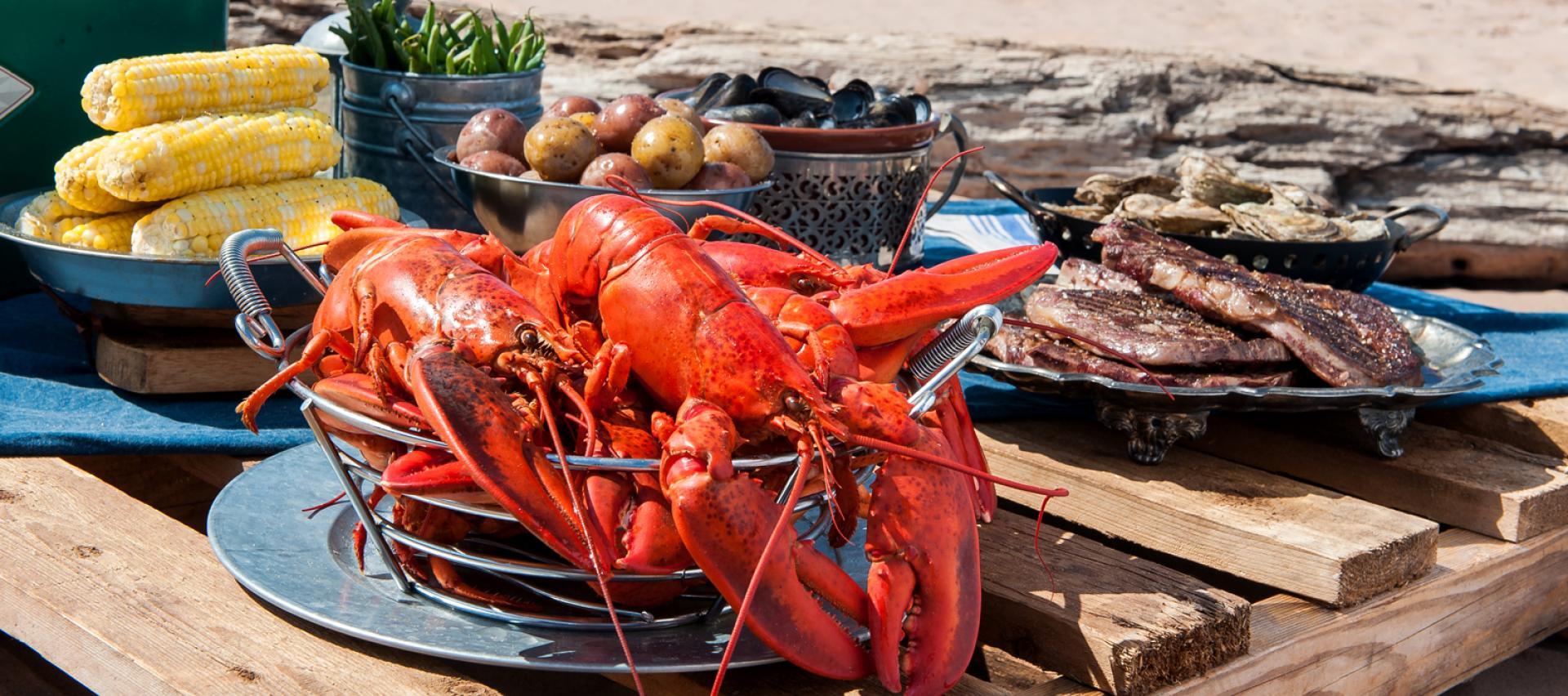 Boiled lobster, steak and corn