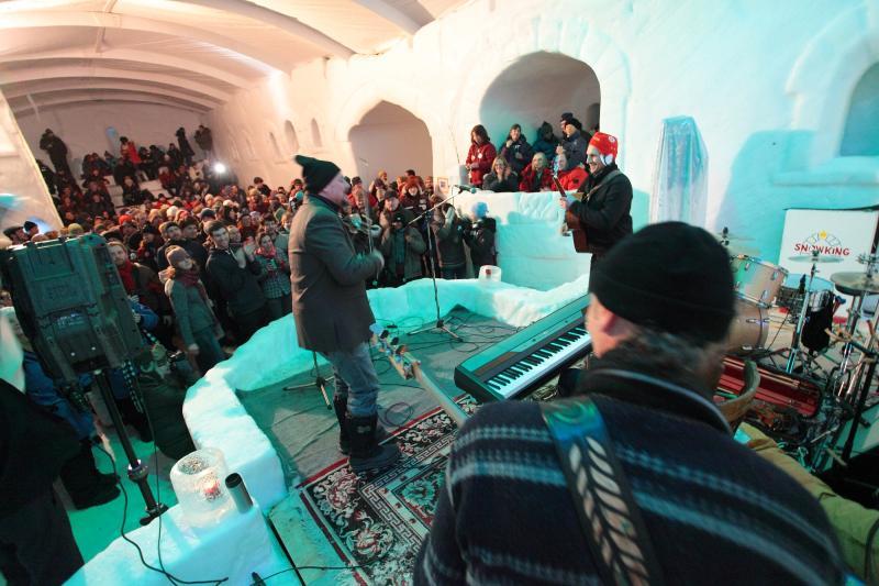 People celebrating inside a structure made of snow