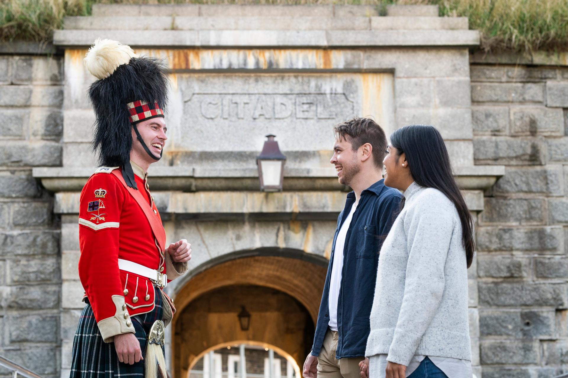 Solider and two tourists in front of the citadel entrance