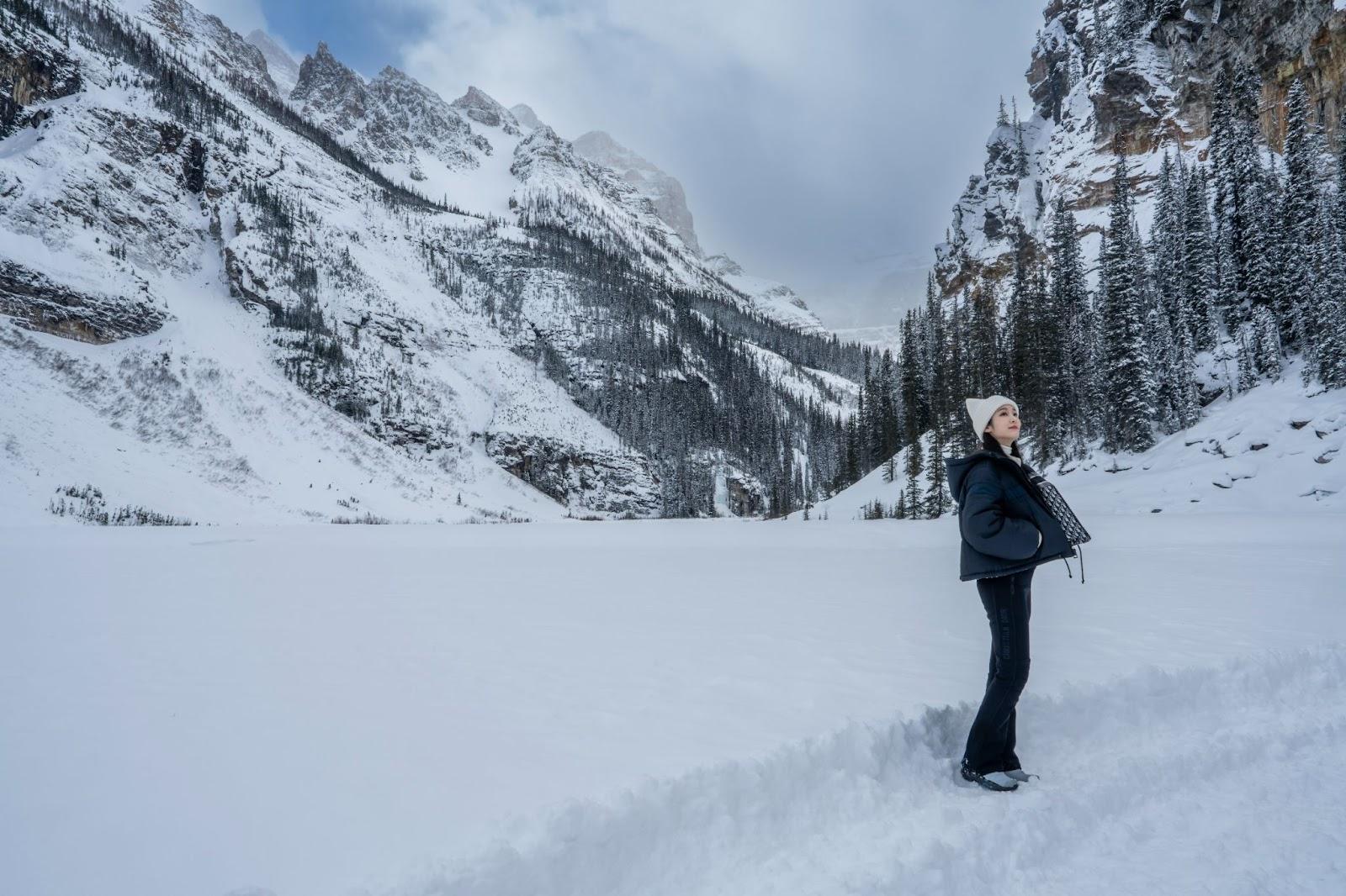 Yuna Kim surveys the mountain range from a snowy plain