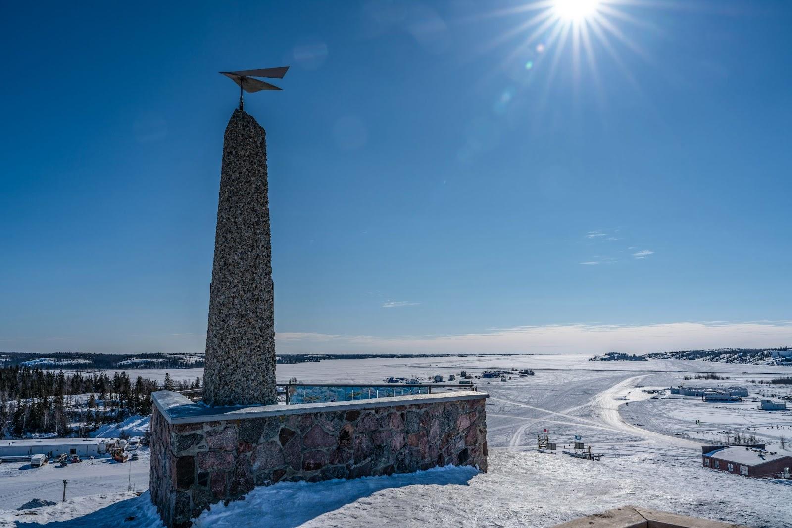 A stone monument in the Canadian North, on a field of snow and ice