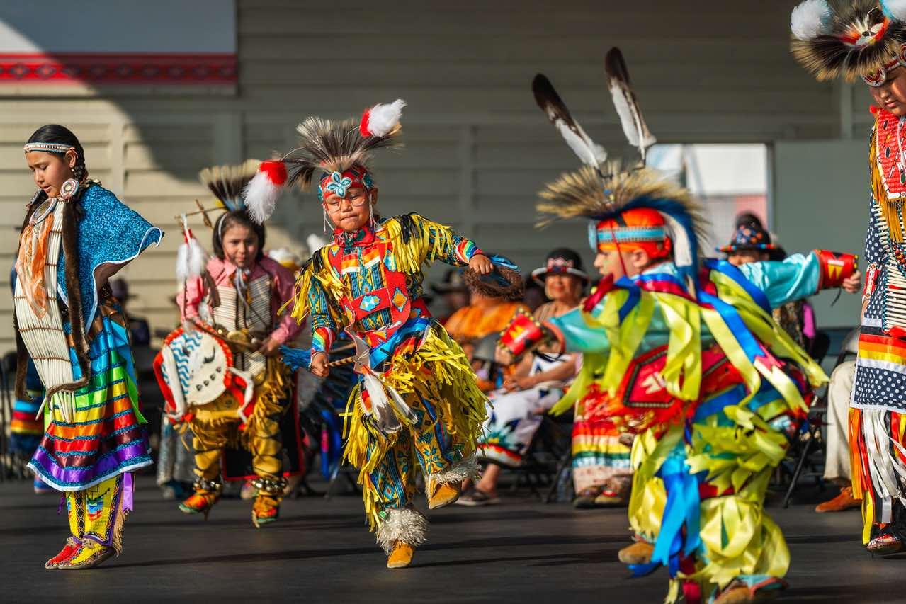 Indigenous child dancers performing at Elbow River camp at the Calgary Stampede