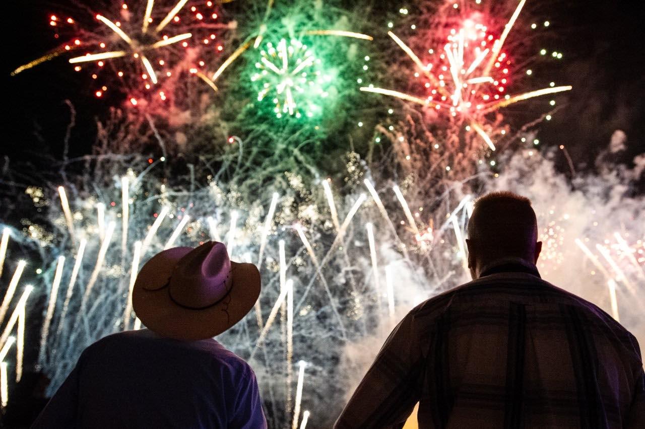 Two people watching fireworks at night