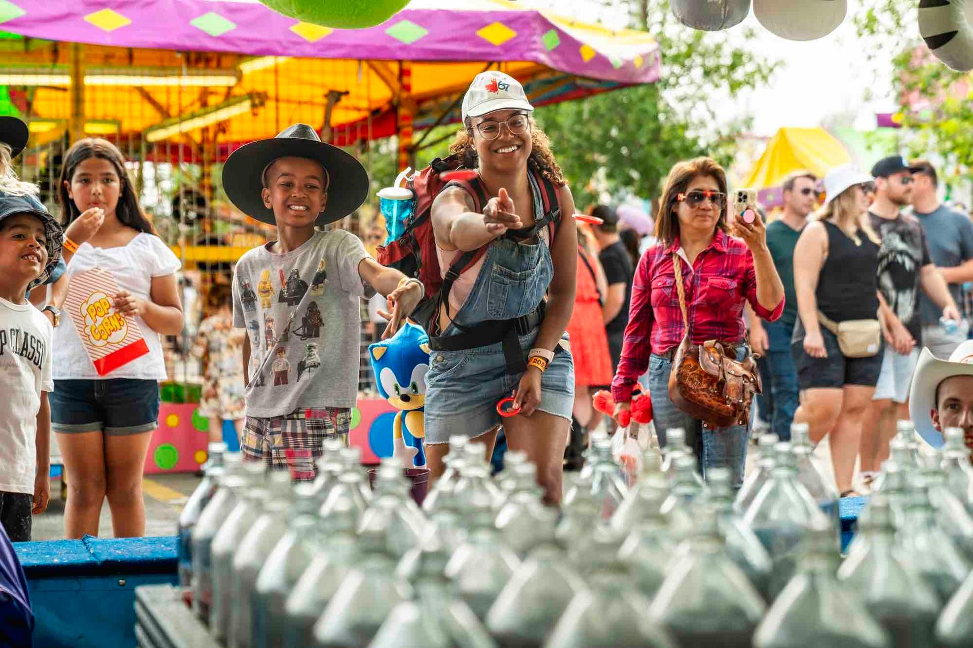 Family playing at the carnival games at the Calgary Stampede