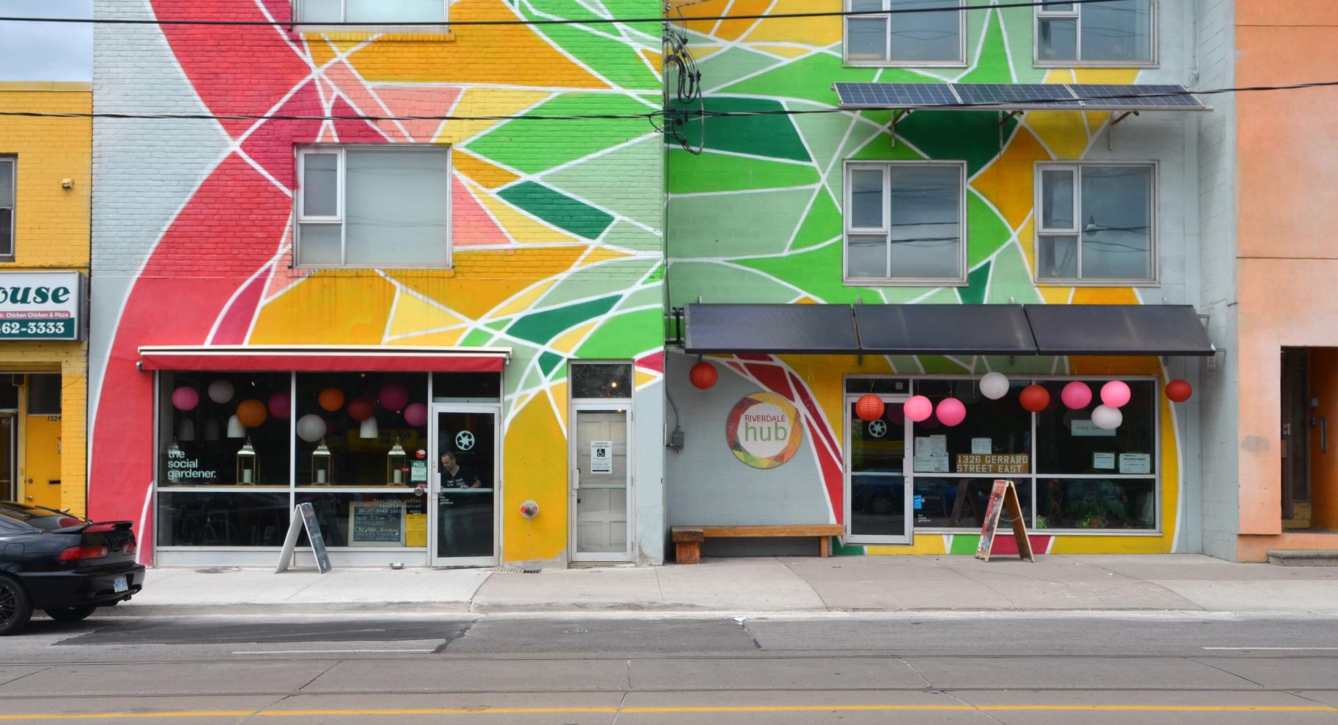 Storefronts painted with colorful murals in Toronto's Little India.