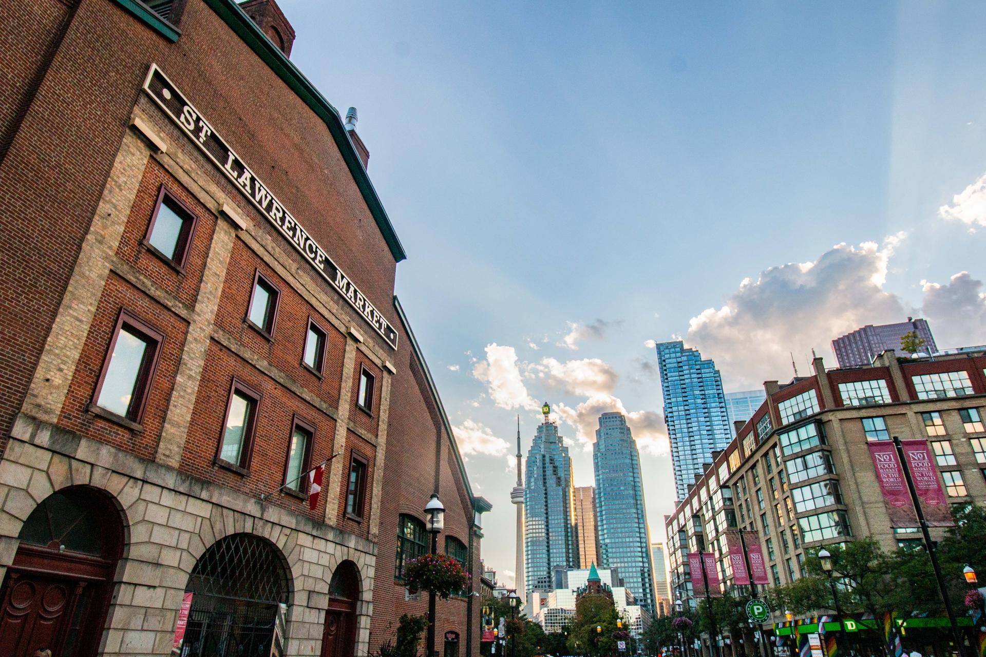 The exterior of the St Lawrence Market with Toronto skyscrapers in the background.