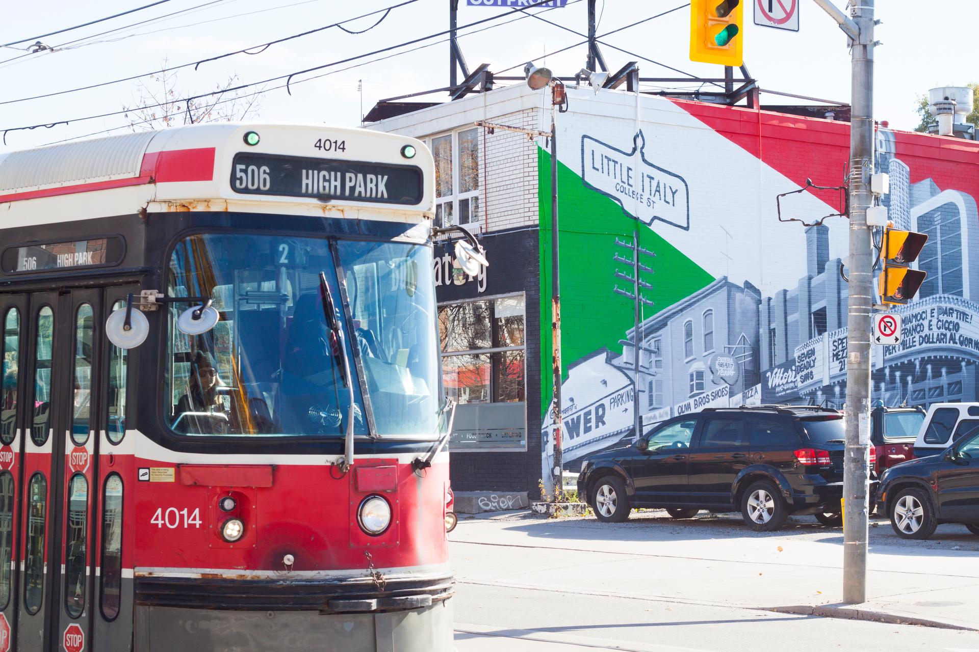 A streetcar moving through Little Italy in Toronto.