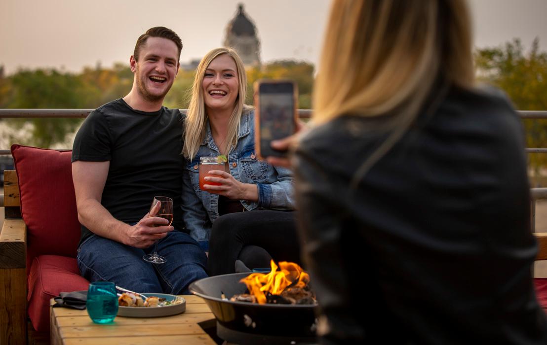 A couple having their photo taken outdoors at Bar Willow Eatery in Regina, Saskatchewan.