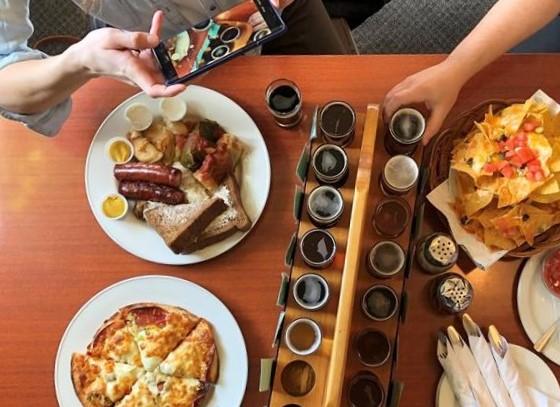 An overhead view of food and drink on a table at Bushwakker Brewpub in Regina, Saskatchewan.