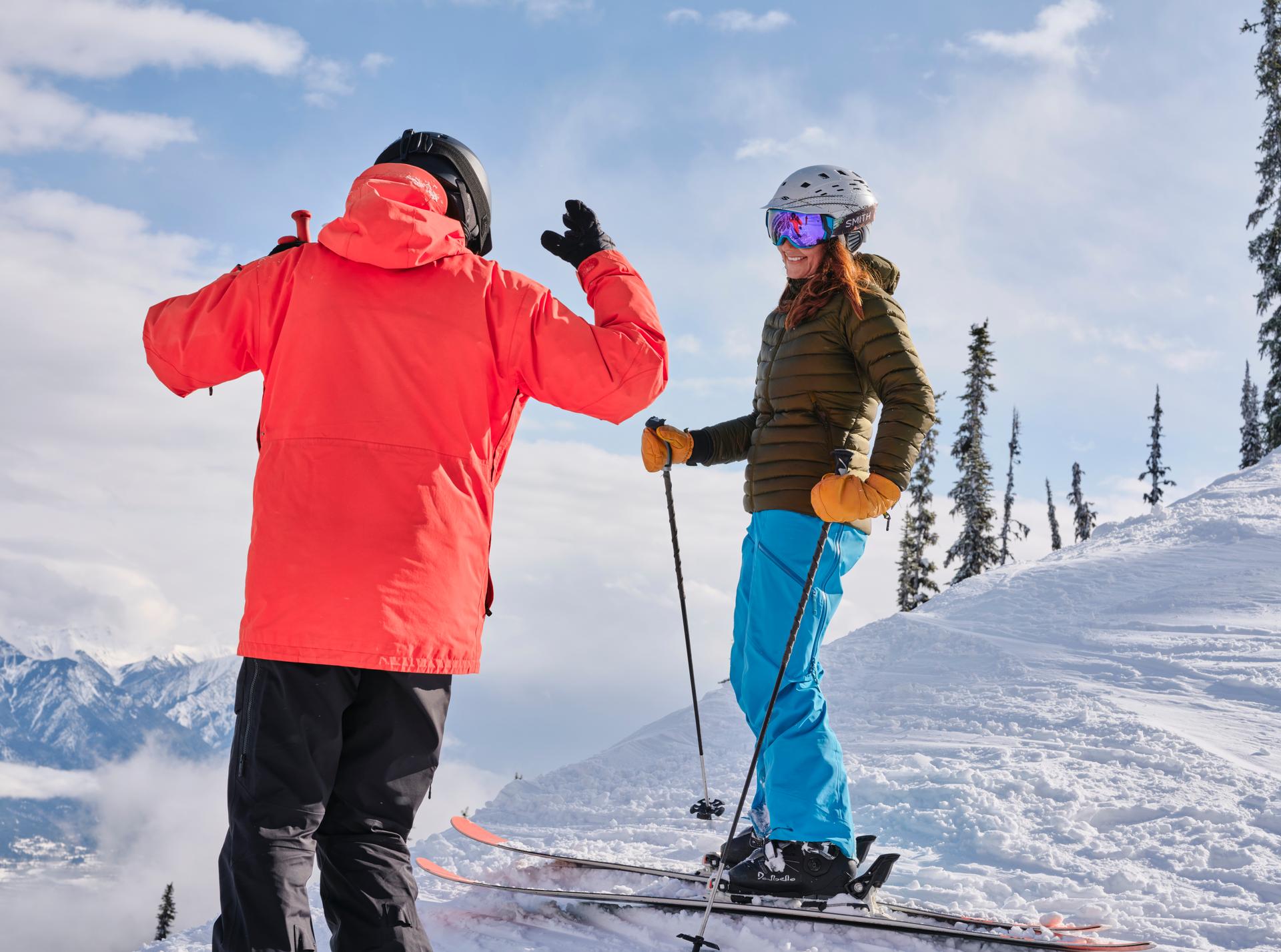 Two skiers on a snowy mountain slope