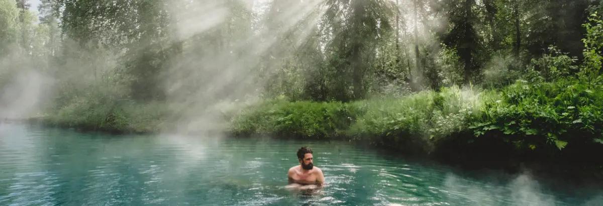 Hero image establishing British Columbia as a destination for soaking in natural hot springs surrounded by forest landscapes.
