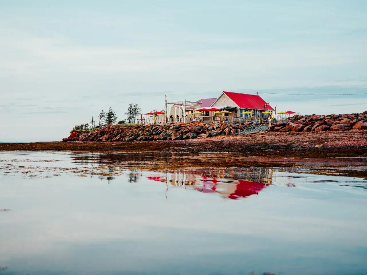 Red sandy shores and lighthouse, Prince Edward Island, Canada.
