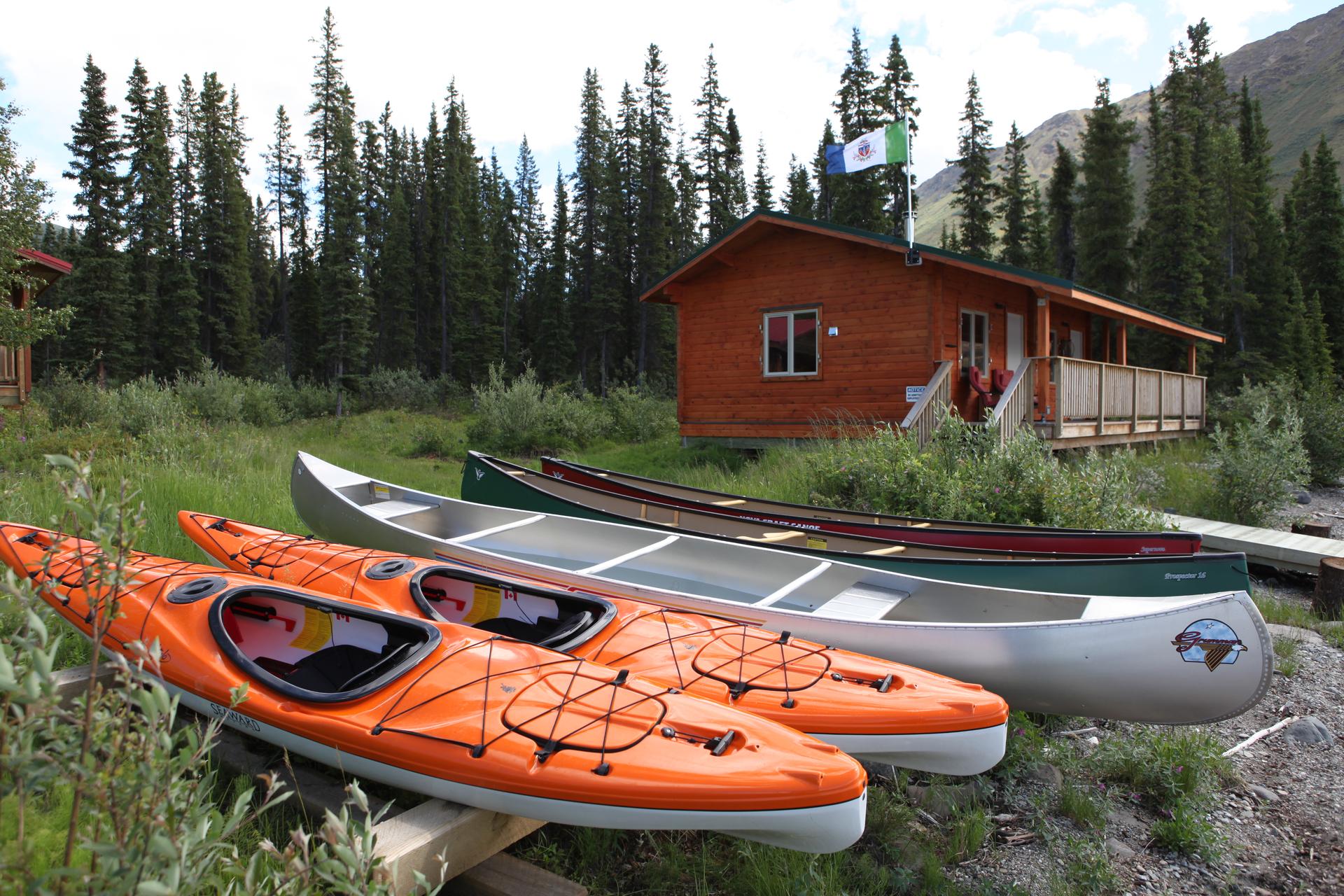 Canoes and kayaks onshore at Tincup Wilderness Lodge, Yukon