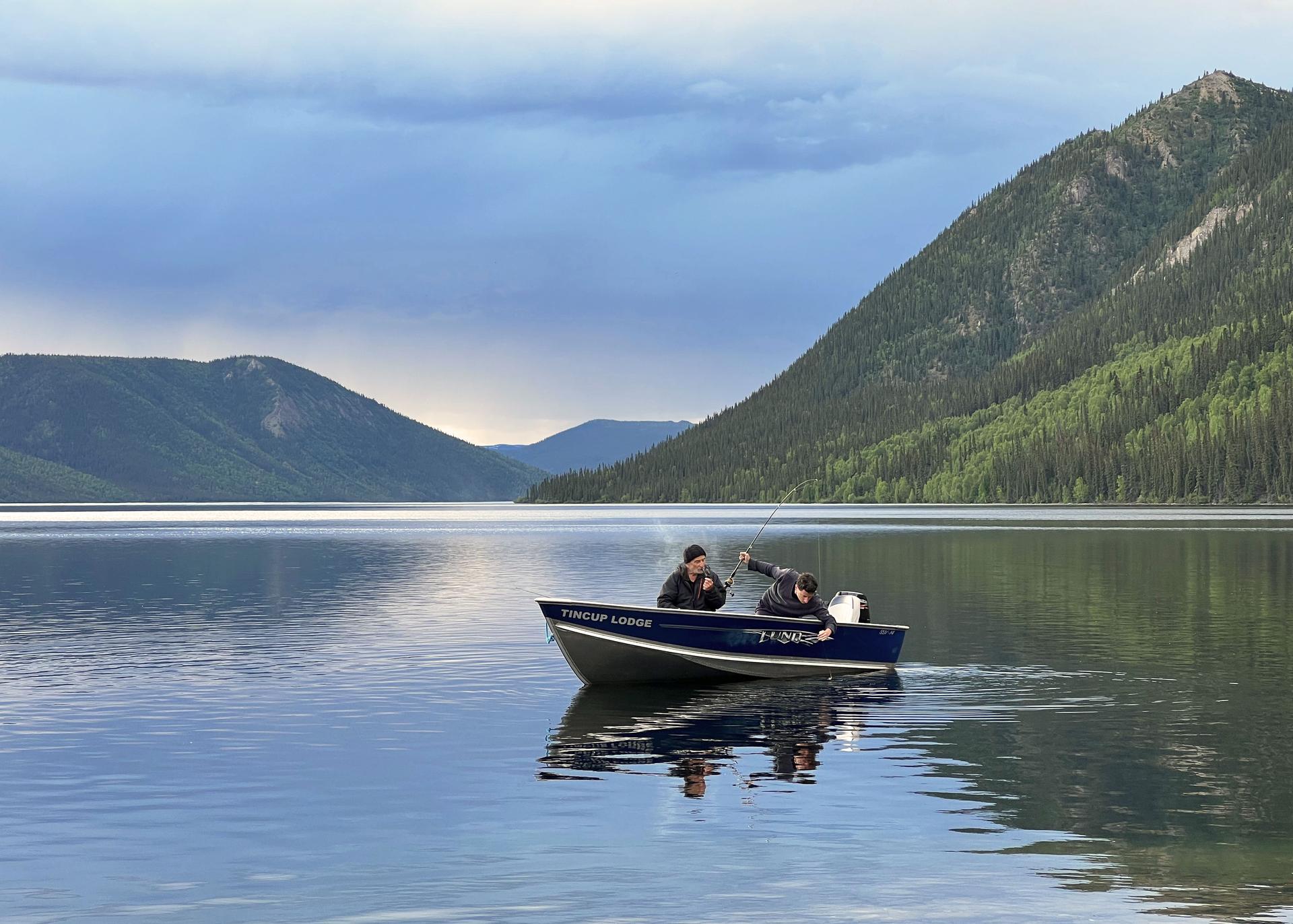 Two men in a fishing boat on Tincup Lake at Tincup Wilderness Lodge, Yukon