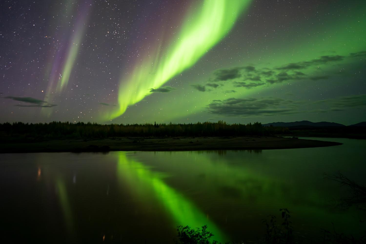 Northern Lights over the Ogilivie River on the Dempster Highway in fall in the Yukon