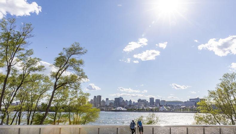 people walking around lake with blue skies