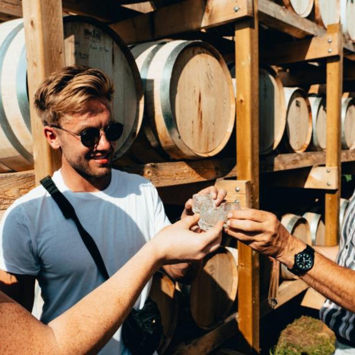 Tourists tasting straight from the barrel at a distillery