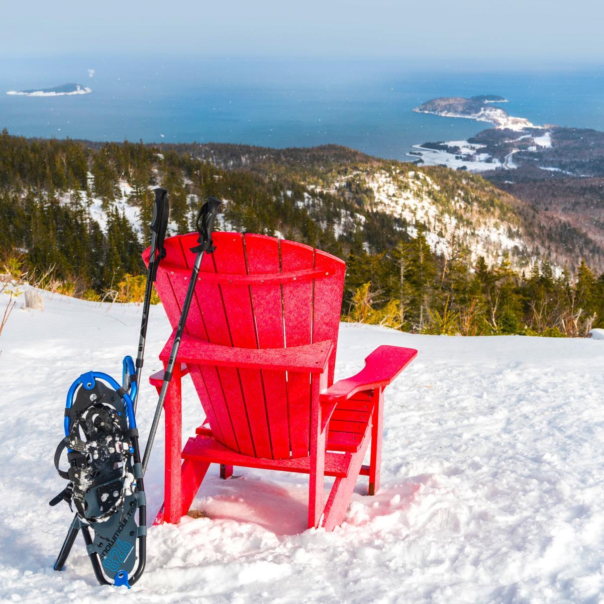 Red chair in the snow overlooking Cape Breton Island