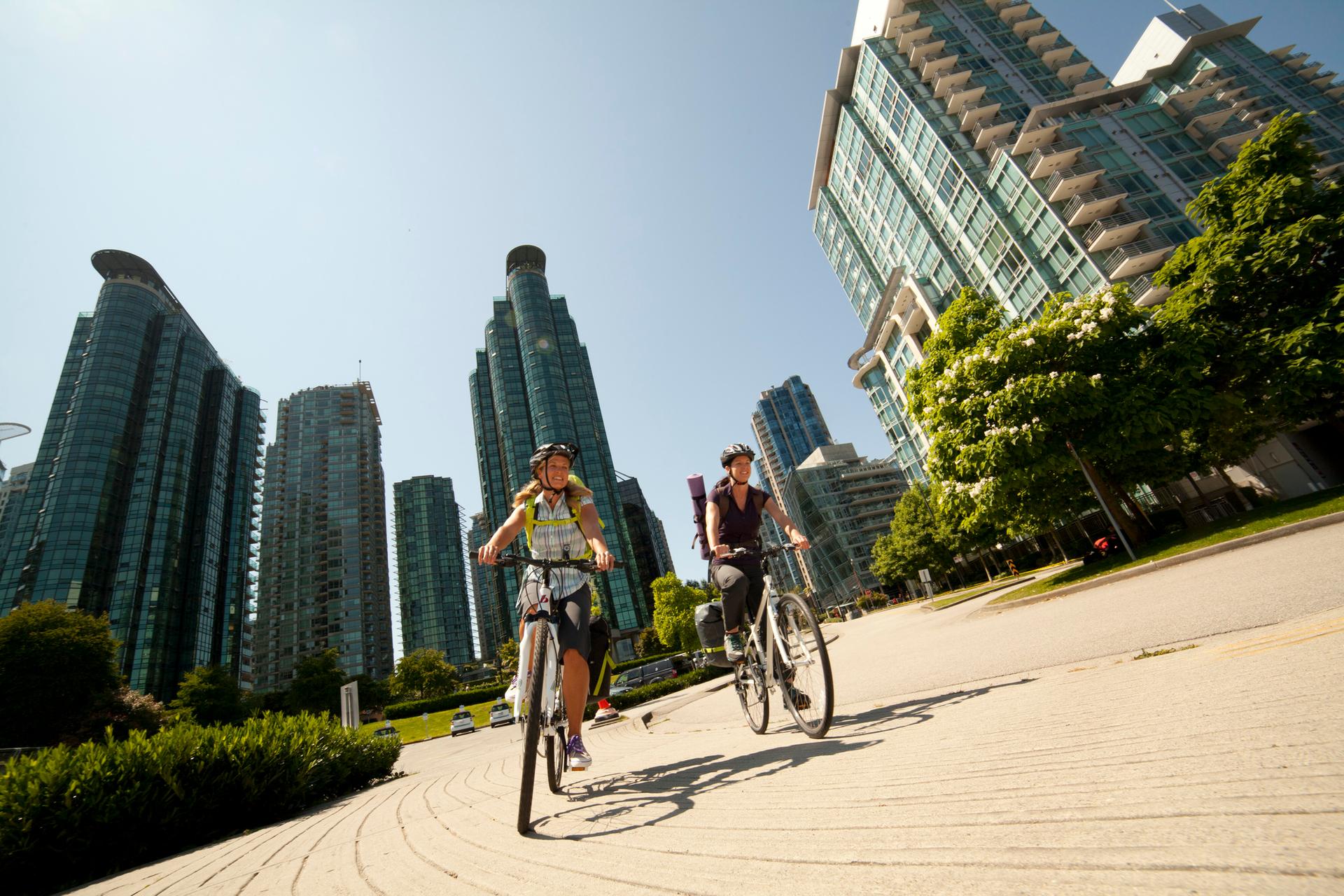 Two cyclists biking outdoors in Vancouver