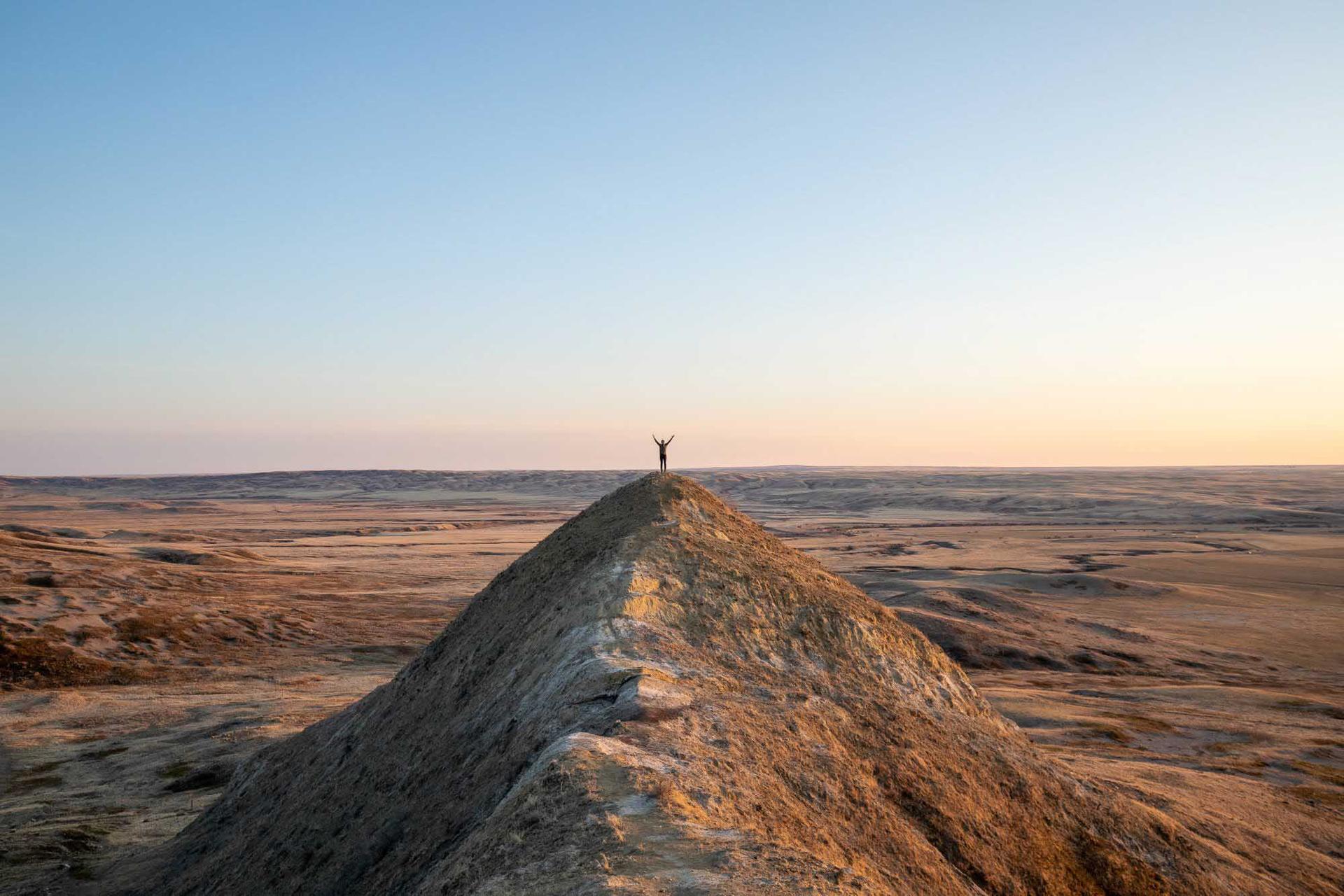 A person atop a peak at Grassland national park in Saskatchewan