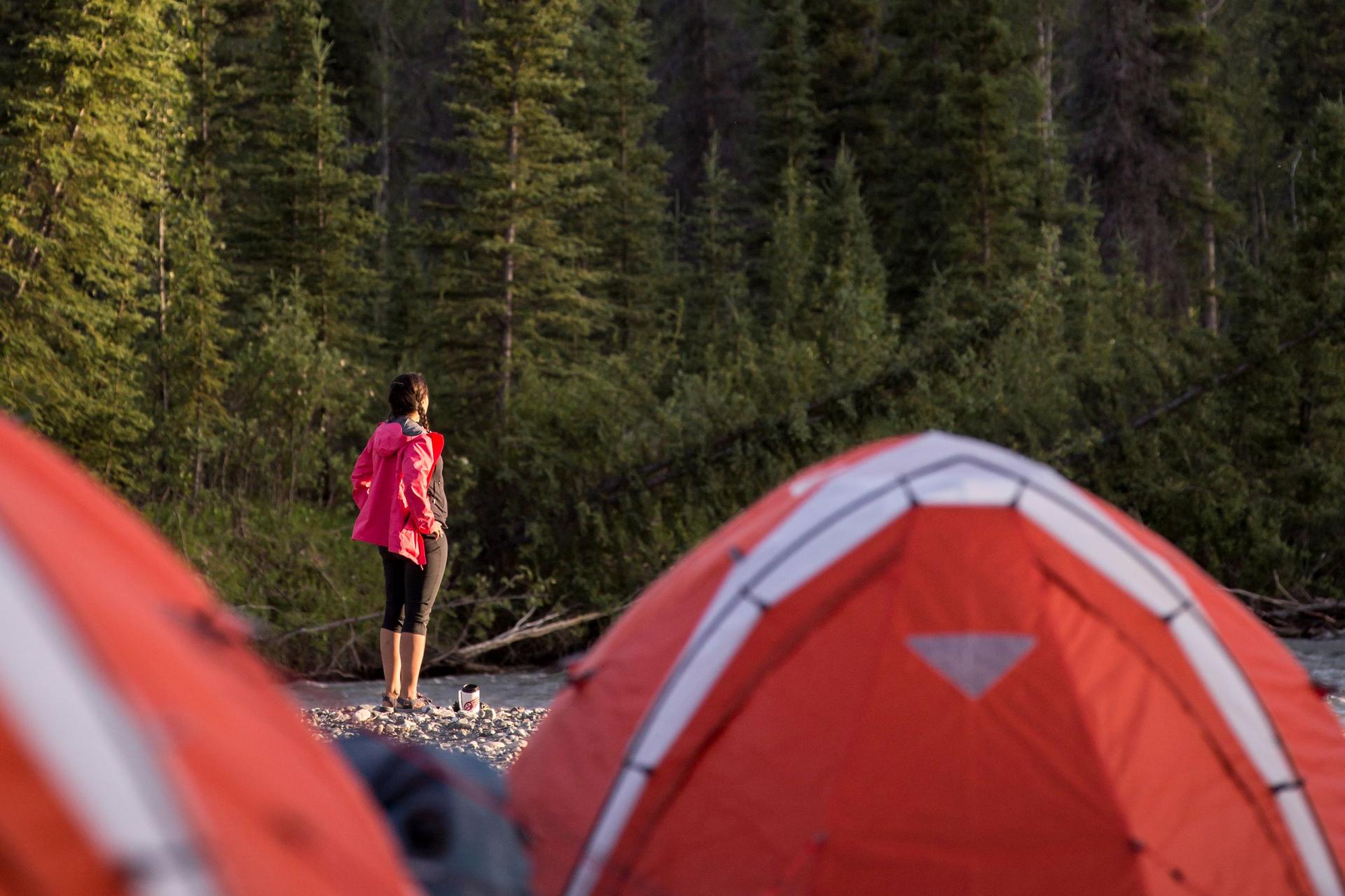 A camper outside two tens in Tatshenshini River, Kluane National Park, Yukon