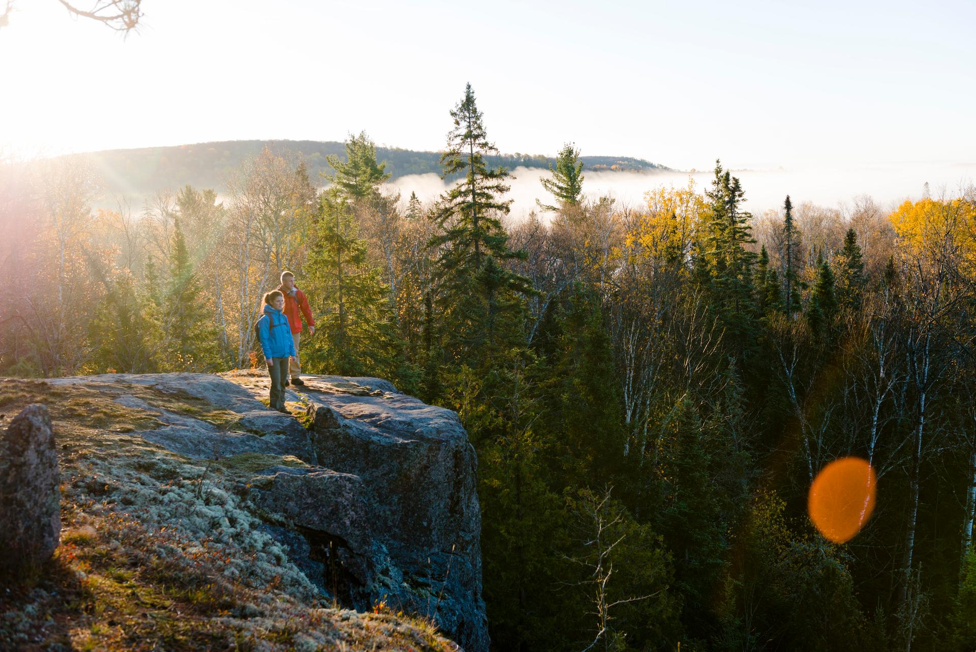 Two hikers look off a cliff in Algonquin park