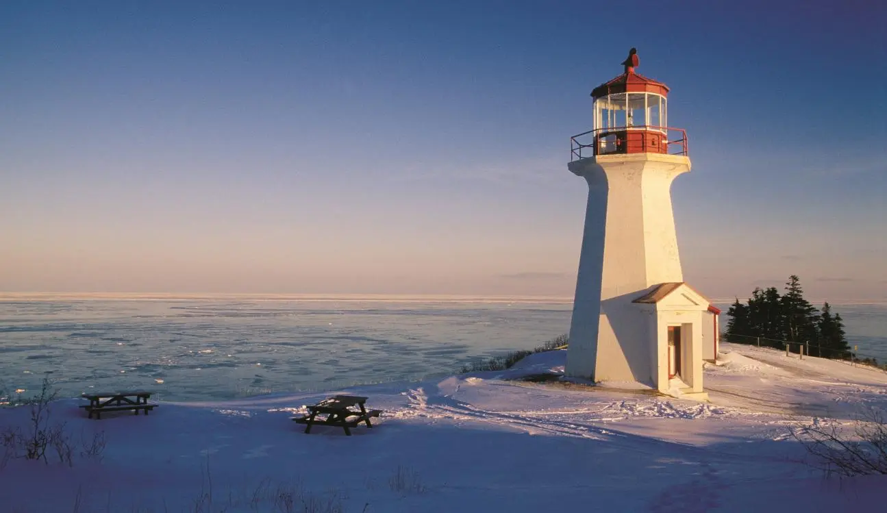 A lighthouse in the snow near the city of Gaspé