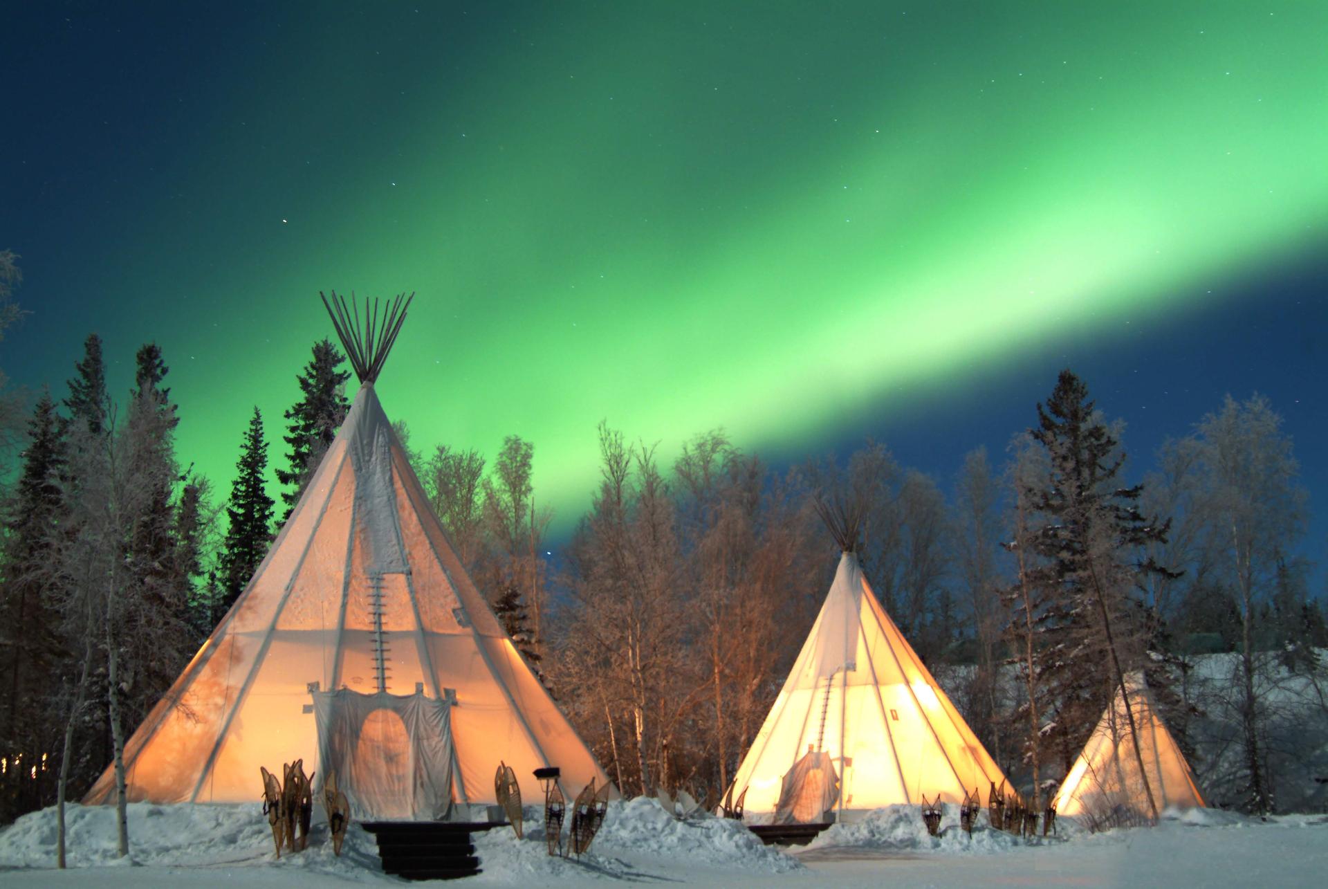 Aurora Village, three teepees under the northern lights, Yellowknife, Northwest Territories, Canada