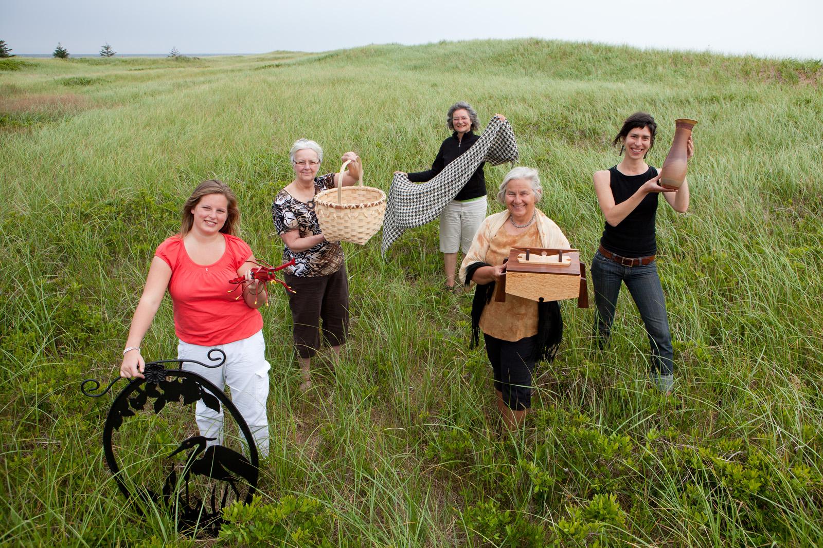 People smiling holding handmade items