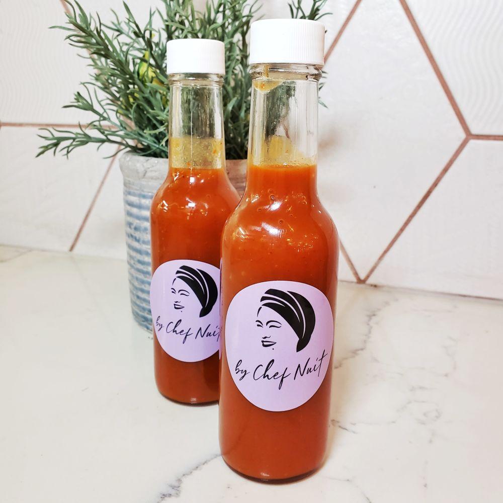 Two bottles of Chef Nuit hot sauce