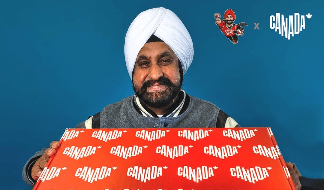 Raptors superfan Nav Bhatia holds a Canada-themed care package