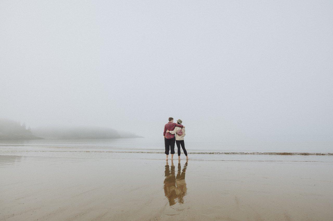 Misty day with two people on the beach