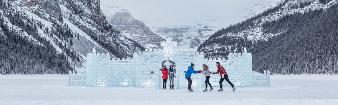 Three people skating in front of an ice castle and snow-covered mountains