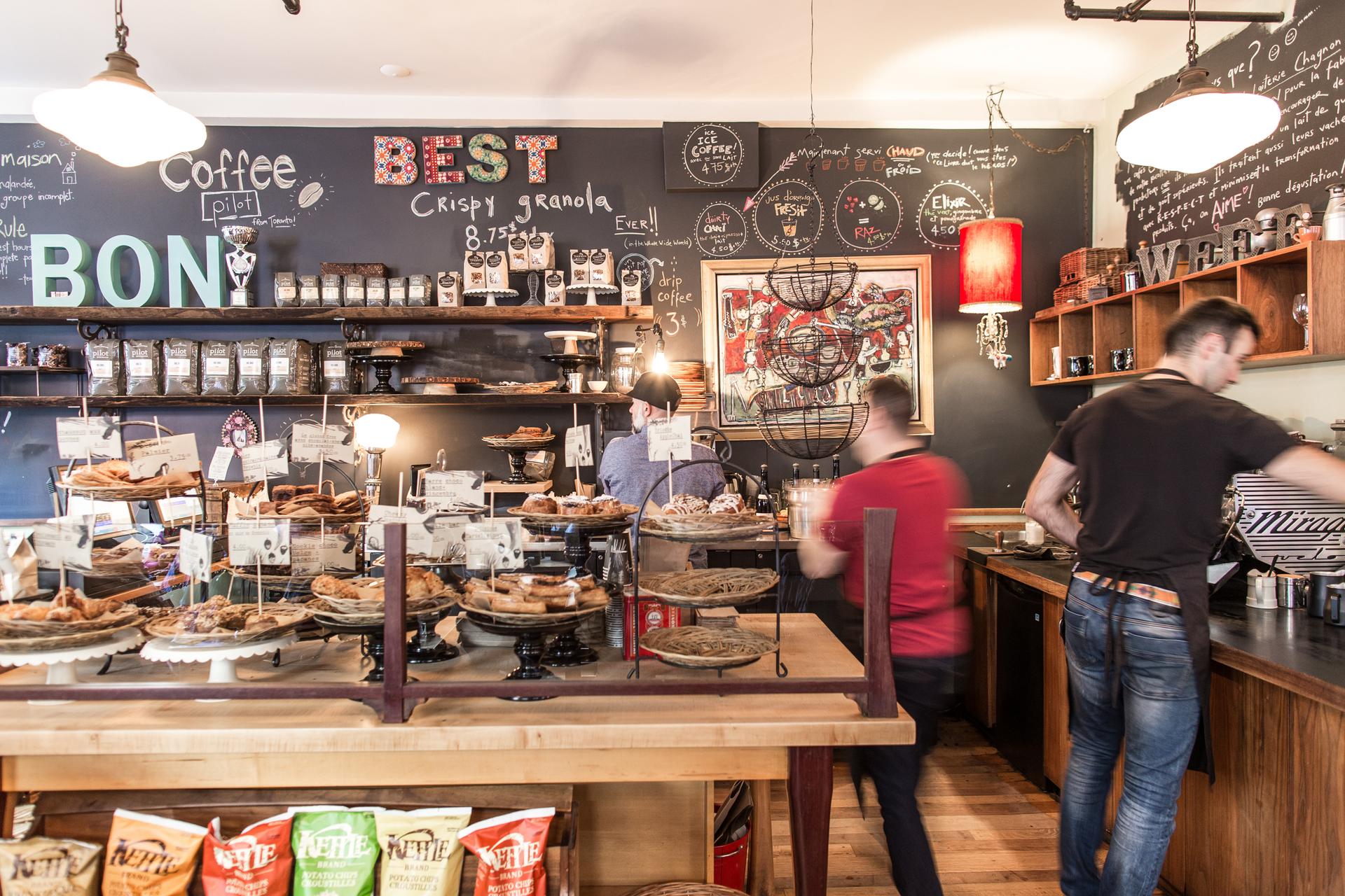 An array of baked goods and employees working at Olive et Gourmando cafe in Montreal.