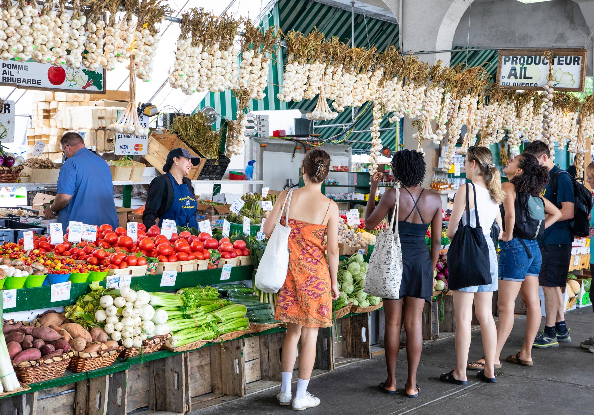 Shoppers at a produce stand in the Jean-Talon Market in Montreal.