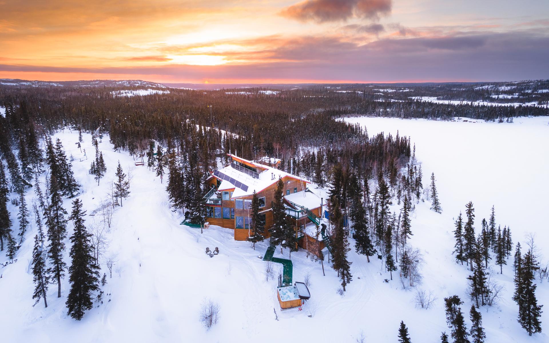 An exterior view of Blachford Lake Lodge in the winter.