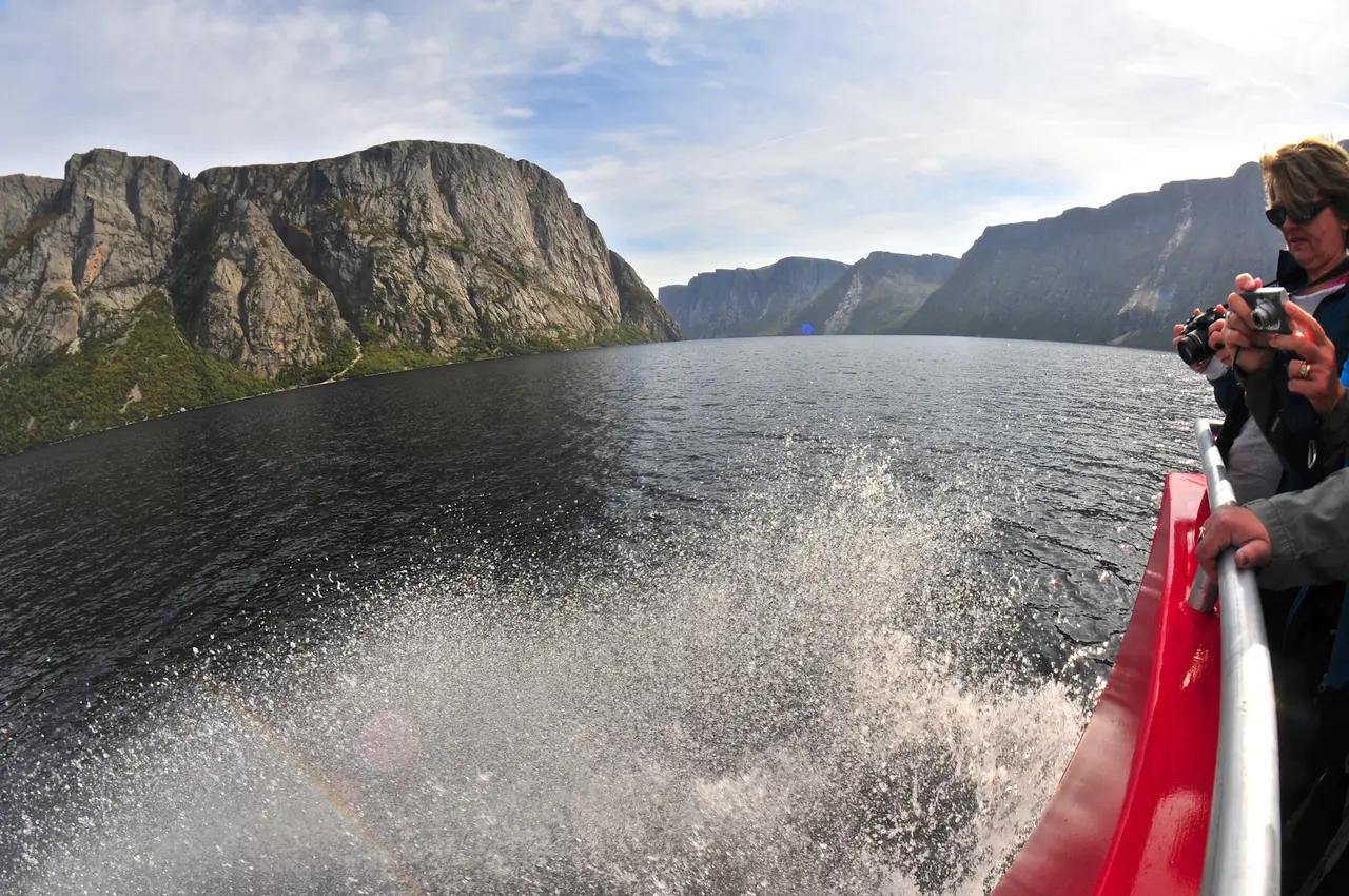 Option 2 context image that shows what ‘boat tour’ means on this fjord—on-water perspective plus the sense of distance between cliff walls, reinforcing why guided commentary and scenic stops change what you notice and learn.