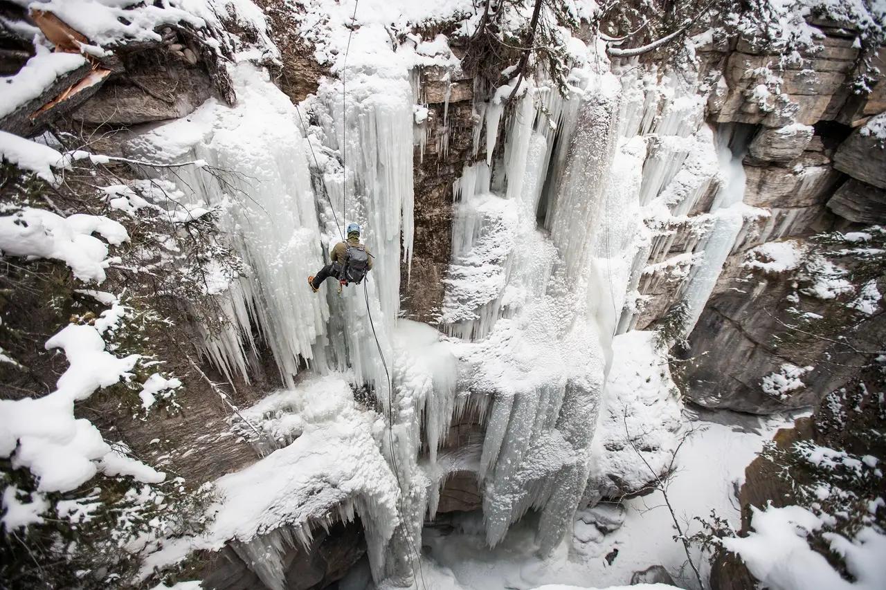 Ice climbing image demonstrates an extreme ‘frozen water’ experience, adding semantic depth by showing that Rockies water features transform into climbable terrain in winter.