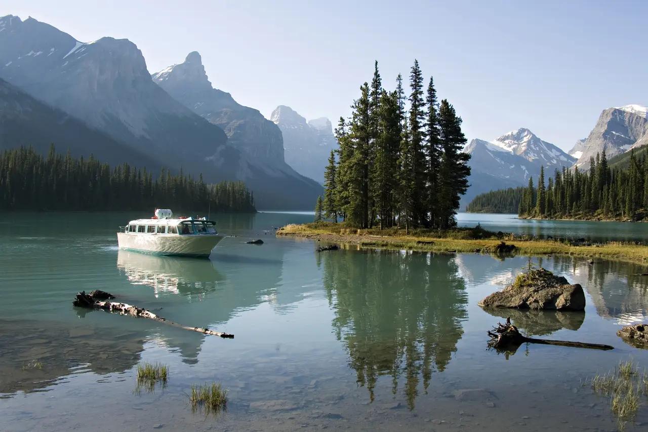 Spirit Island on Maligne Lake used as the article’s ‘signature Jasper water scene’—a visual shorthand for glacier-fed alpine lakes and why Jasper belongs in a Rockies itinerary distinct from Banff.