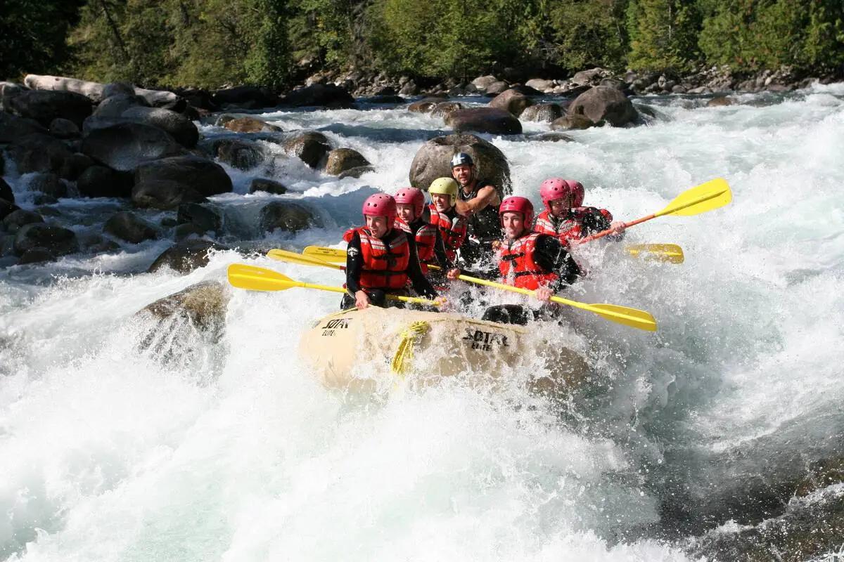 A group of rafters navigates splashing whitewater rapids on a snowmelt-fed river near Squamish, showcasing the guided rafting adventures that turn BC’s mountain rivers into accessible thrills for families and adrenaline seekers alike.