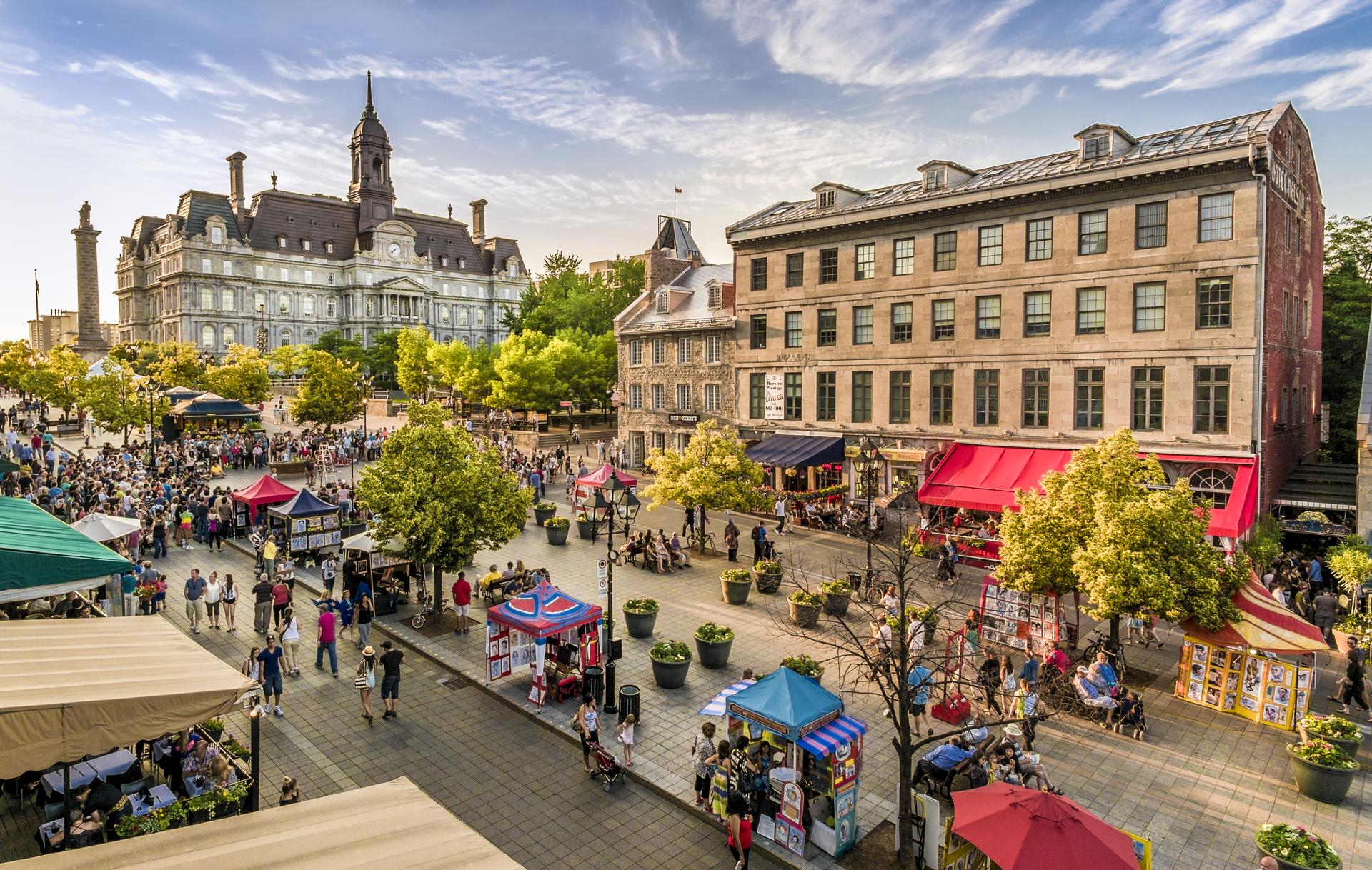 Busy historic square with street vendors and city hall in Montréal