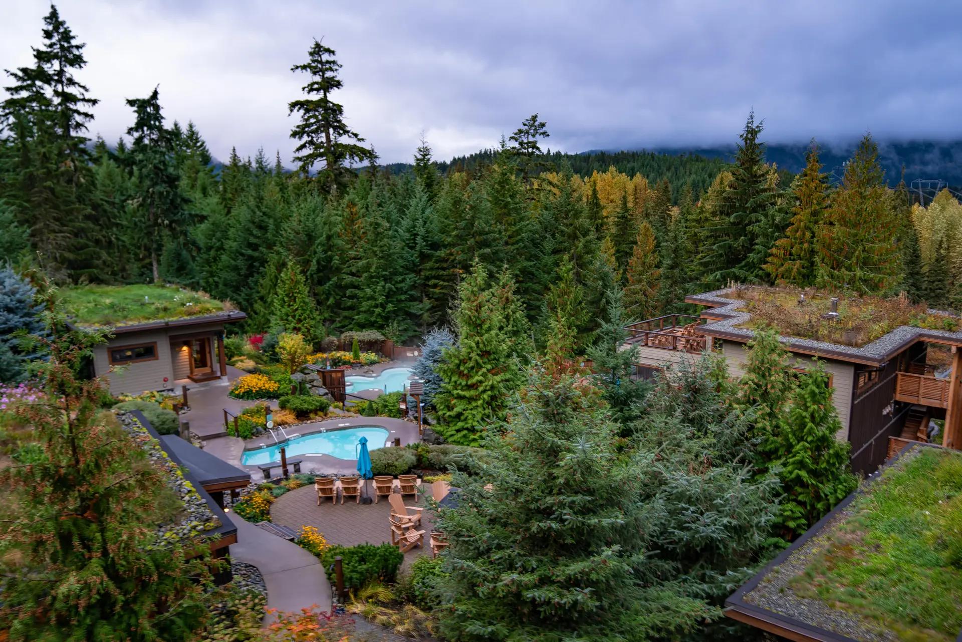 Outdoor thermal pools surrounded by coastal forest at Scandinave Spa Whistler, a year-round Nordic spa in British Columbia.