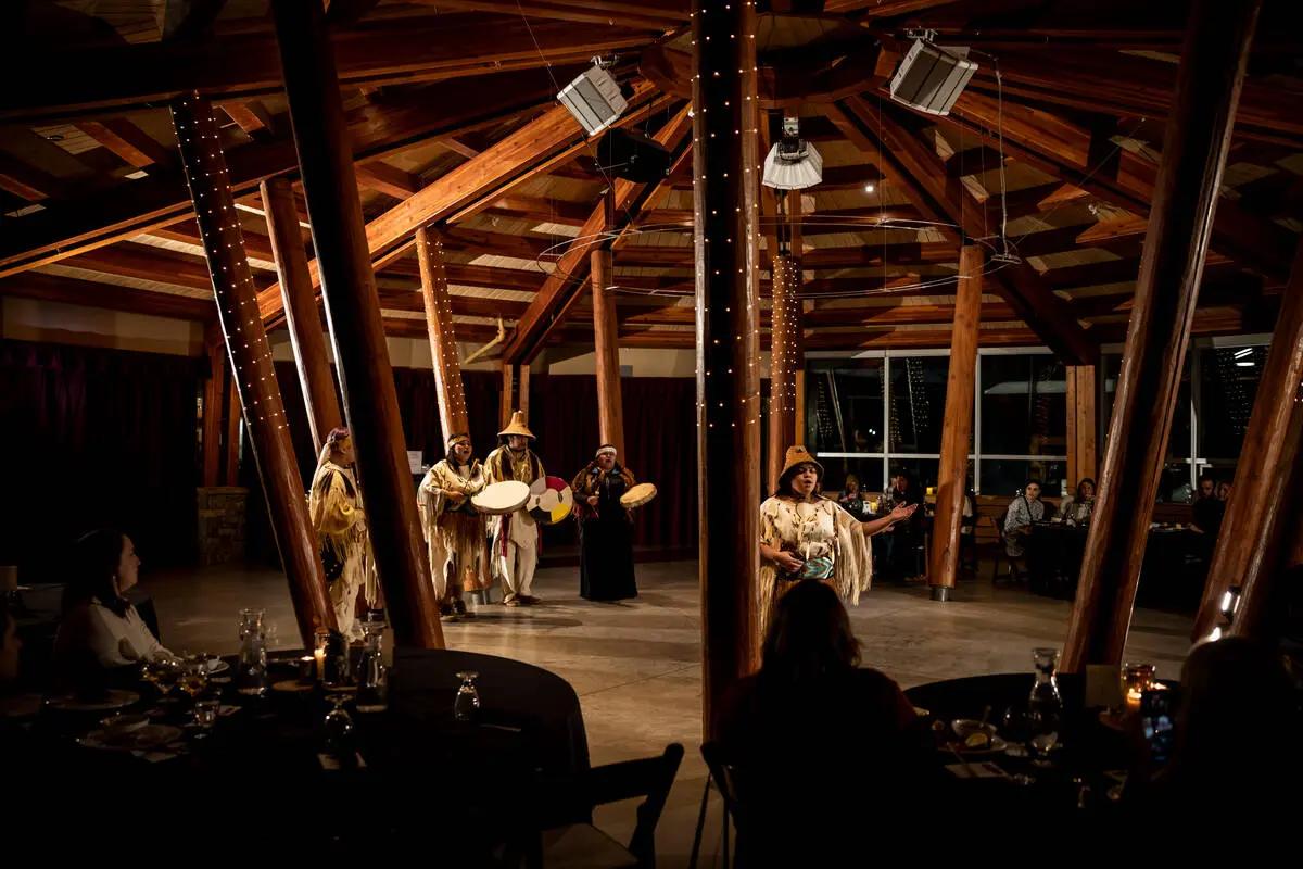 Indigenous performers in traditional regalia at Squamish Lil'wat Cultural Centre during the Winter Feast in Whistler.