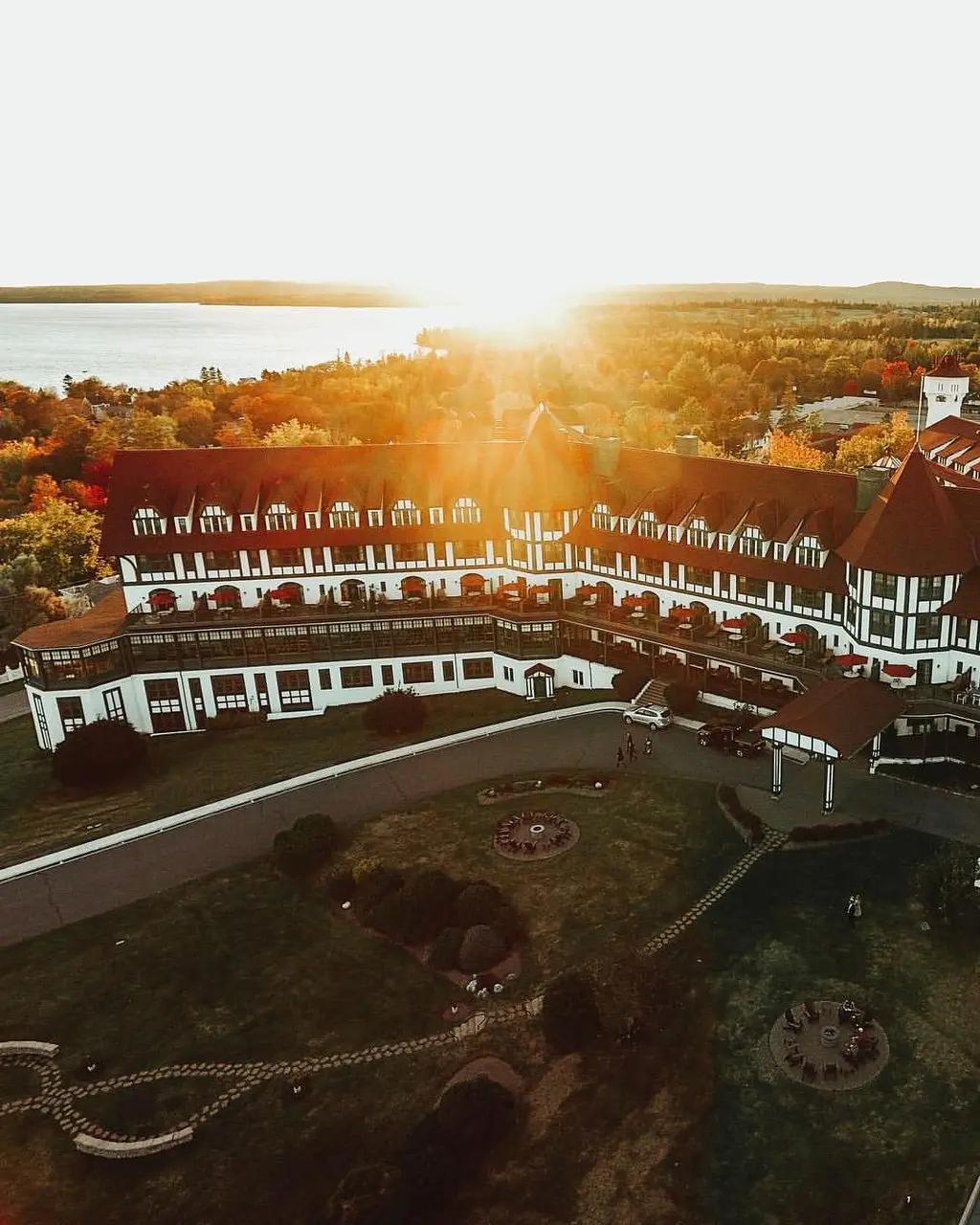 Aerial sunset view of the grand Tudor Revival Algonquin Resort surrounded by autumn foliage in St. Andrews-By-The-Sea, New Brunswick.
