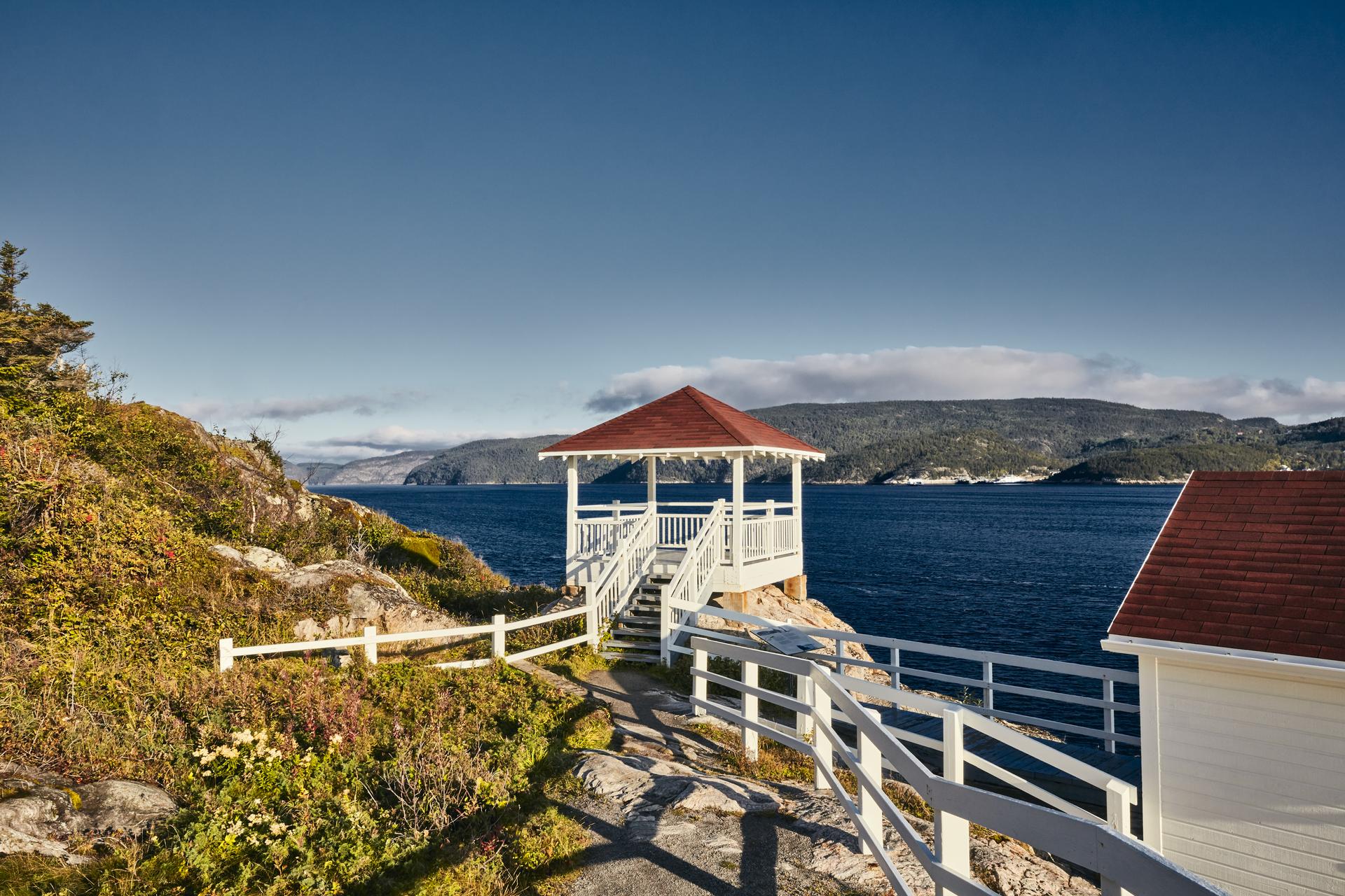 A wooden observation platform overlooking the Saguenay Fjord and St. Lawrence River confluence at the Pointe-Noire Interpretation and Observation Centre, Québec