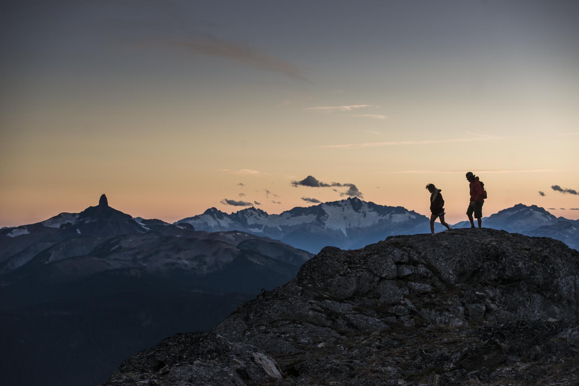 People hiking a mountain peak in Whistler, British Columbia