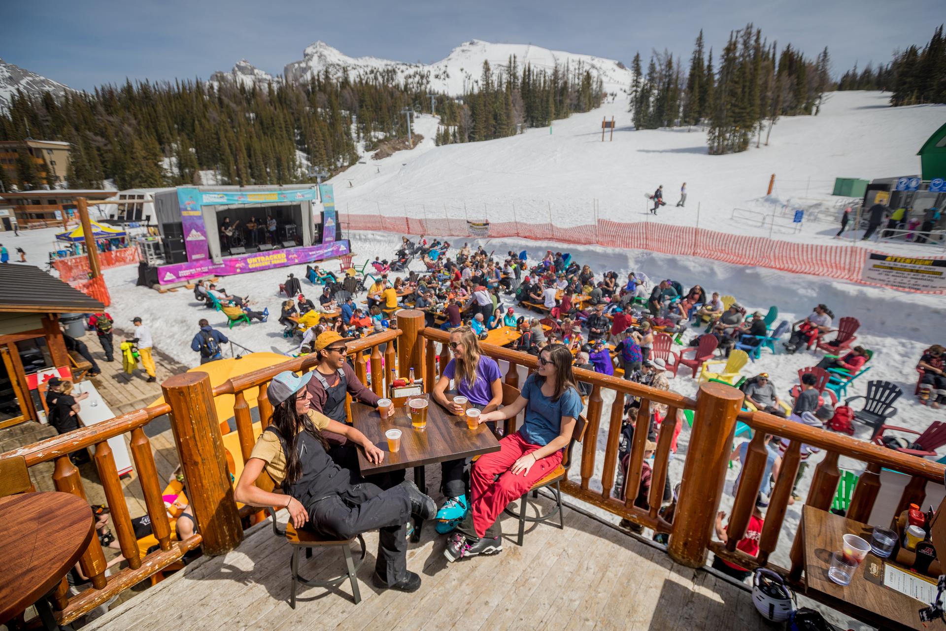 people on a patio outside in sunshine village